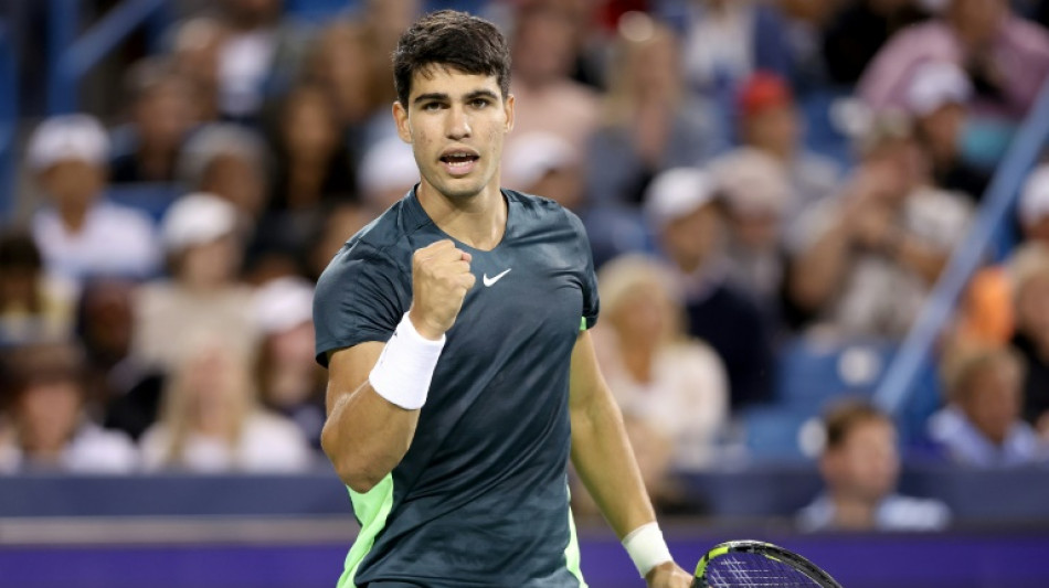 Alcaraz battles through rain, holder Garcia out