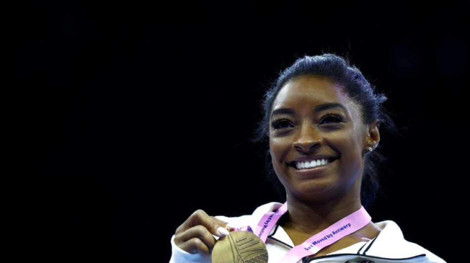 Biles dazzles with beam and floor golds to reach 23 world titles
