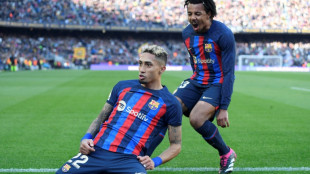 Raphinha header helps 10-man Barca to nervy Valencia win