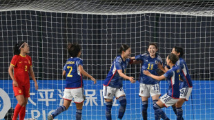 Japan set up North Korea showdown, runner wins again after ban