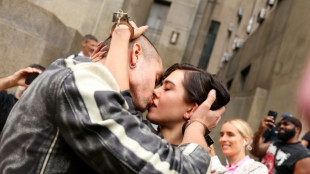 Empire State Building climbers kiss outside court after viral proposal