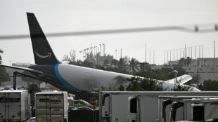 Amazon cargo plane overshoots Miami runway, hits vehicles, catches fire